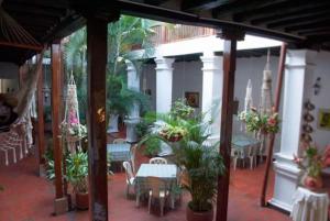 希龙Hotel Las Nieves的带桌椅和植物的露台