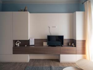a living room with a tv on a cabinet at Garden Rovinj in Rovinj
