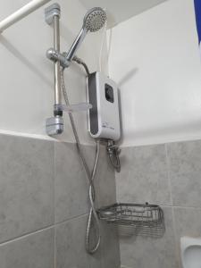 a shower with a shower head in a bathroom at Amaia Steps Capitol Central N814 in Bacolod