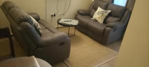 a living room with a couch and a chair at Nyatana suite (Fully furnished apartments) in Narok
