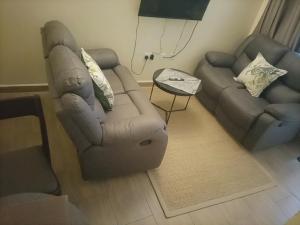 a living room with a couch and a recliner at Nyatana suite (Fully furnished apartments) in Narok