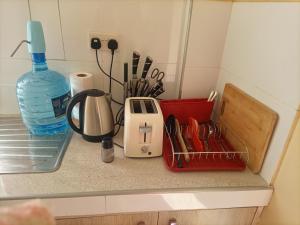 a kitchen counter with a toaster and utensils at Nyatana suite (Fully furnished apartments) in Narok
