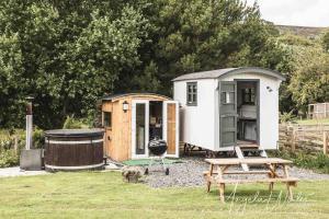 a tiny house next to a grill and a wooden house at Robins Rest in the North York Moors in Rosedale Abbey