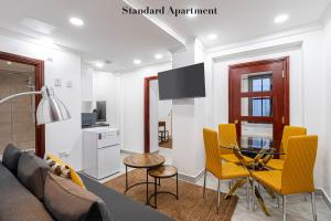 a living room with a couch and a glass table at Stylish Apartment Kensington in London