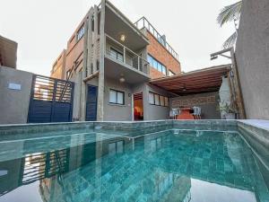 ein Swimmingpool vor einem Haus in der Unterkunft Excelente aparamento em Milagres à 100 metros da Praia in São Miguel dos Milagres