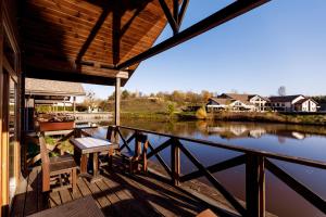 a view of a river from the porch of a house at Equides club in Lesniki