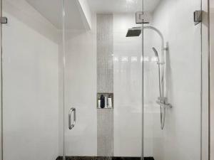 a shower with a glass door in a bathroom at Modern Meridian 2 Bedroom (Chapin 3) in Washington, D.C.