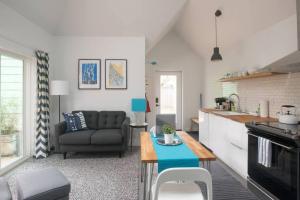 a kitchen and living room with a couch and a table at The Hawthorne Hideaway in Portland