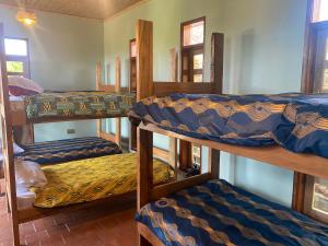 a group of four bunk beds in a room at Apuuli Safaris and Cottages in Kasusu