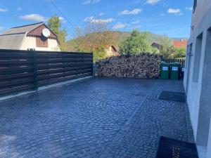 a brick driveway with a fence and a stone wall at SKH R - 1 Bedroom in Praid