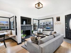 a living room with a couch and a fireplace at Picture Perfect Bungalow in the heart of DT Vancouver in Vancouver