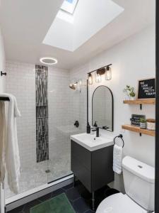 a bathroom with a sink and a shower and a toilet at Picture Perfect Bungalow in the heart of DT Vancouver in Vancouver +26 photos