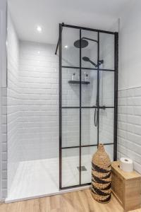 a shower with a glass door in a bathroom at 1908 the Gardens in Belfast