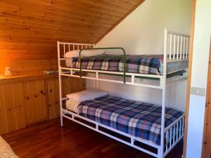 a room with two bunk beds in a cabin at Sopra la Scaletta in Lavarone