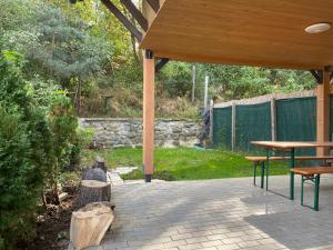 a pavilion with a table and benches on a patio at SKH L - 1 Bedroom in Praid