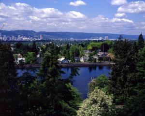 a view of a lake with a city in the background at Renovated Hawthorne Retreat in Portland