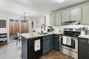 uma cozinha com armários verdes e um fogão forno superior em Vancouver Escape, Spacious 3-Bdrm Private Home em Vancouver