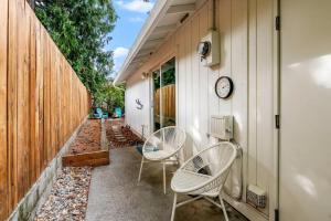 a patio with two chairs and a clock on a house at Vancouver Escape, Spacious 3-Bdrm Private Home in Vancouver