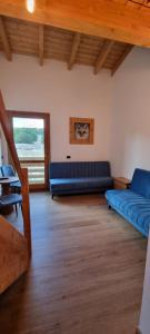 a living room with a blue couch and a table at Campaegli resort in Campaegli