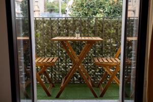 a wooden table and two chairs on a balcony at L'angolo di Acitrezza in Acitrezza