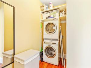 a laundry room with a washer and dryer in it at NW Studio with a View in Portland