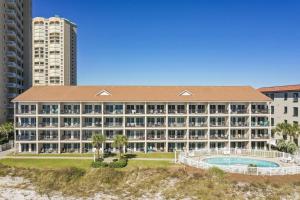 a large hotel with a swimming pool and a building at Windancer 202 in Destin