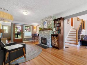 un soggiorno con camino e scala di Alberta Arts with Hot Tub and Yoga Studio a Portland