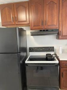a kitchen with a stainless steel stove and wooden cabinets at Pet Friendly, 30+ Night Stay in Johnson City