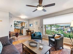 a living room with a couch and a ceiling fan at Casa Azul Near Alberta Arts - Dog Friendly in Portland