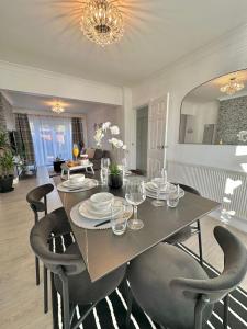 a dining table and chairs in a living room at Luxurious family home in West Midlands in Northfield