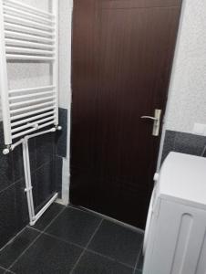a bathroom with a brown door and a toilet at Guest House Arsha in Kazbegi +38 photos