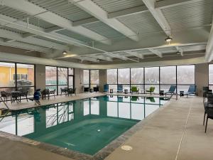a large pool with green water in a building at Hampton Inn Scranton at Montage Mountain in Scranton