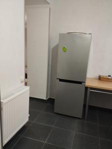 a kitchen with a refrigerator with a sticker on it at Guest House Arsha in Kazbegi