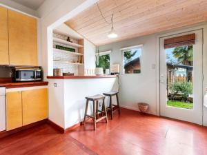 a kitchen with a bar and two stools at Casa del Sol - Walk to Alberta Arts District in Portland