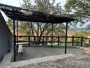 a pavilion with a bench on a patio at Bodega típica en El Molar sin camas ni dormitorios in El Molar