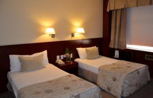 Postel nebo postele na pokoji v ubytování Bisonte Palace Hotel