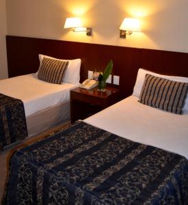 Postel nebo postele na pokoji v ubytování Bisonte Palace Hotel