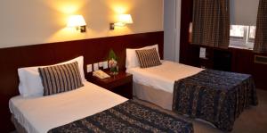 Postel nebo postele na pokoji v ubytování Bisonte Palace Hotel