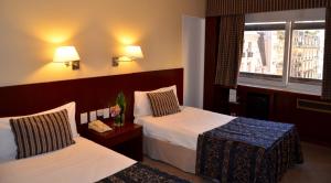 Postel nebo postele na pokoji v ubytování Bisonte Palace Hotel