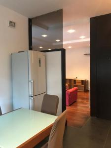a kitchen with a table and a refrigerator at Casa Vacanze Ily ai Colli in Naples