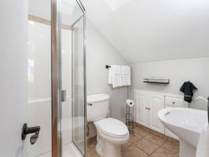 a white bathroom with a toilet and a sink at The Auric Door Inn on N Mississippi in Portland +19 photos