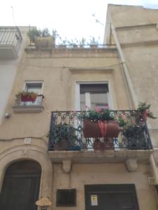 a building with two balconies with potted plants on it at La Chicca in centro Altamura in Altamura