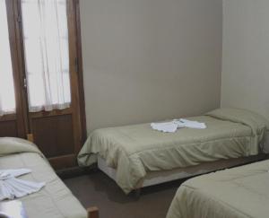 מיטה או מיטות בחדר ב-Gran Hotel Huerta Grande