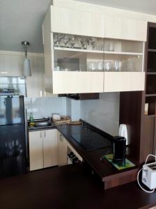 a kitchen with a black refrigerator and a black counter top at VISTAMAR COSTALILENES CONCON in Concón