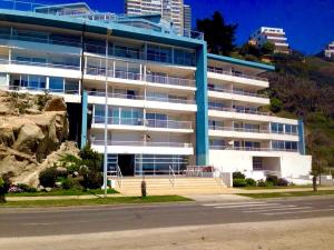 an apartment building with a parking lot in front of it at VISTAMAR COSTALILENES CONCON in Concón