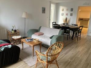 a living room with a couch and a table at Gîte Ty Guen à Paimpol in Paimpol