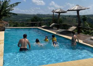 ECOLODGE PIEDRA Y AGUA في إل سوبربيو: مجموعة من الأشخاص في حمام السباحة