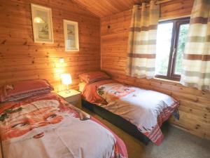 een slaapkamer met 2 bedden in een blokhut bij Hawthorne Lodge in Skinningrove