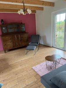 a living room with a couch and a chair and a table at Ferienhaus Melzower Waldhaus Montagewohnung in Melzow