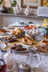 a table topped with plates of pastries and other foods at Villa da Esperança in Campos do Jordão
